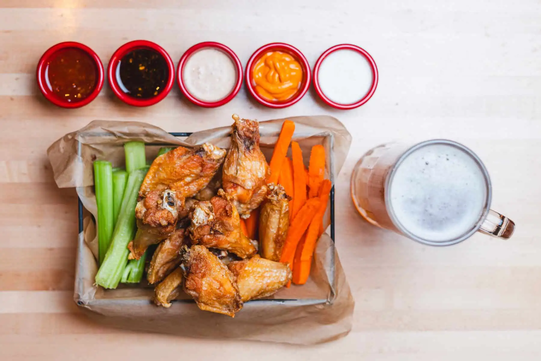 Chicken wings and beer sit atop a table inside the dog-friendly Ruby's Pizzeria & Grill in Logan, UT. Photo by Ruby's Pizzeria & Grill.