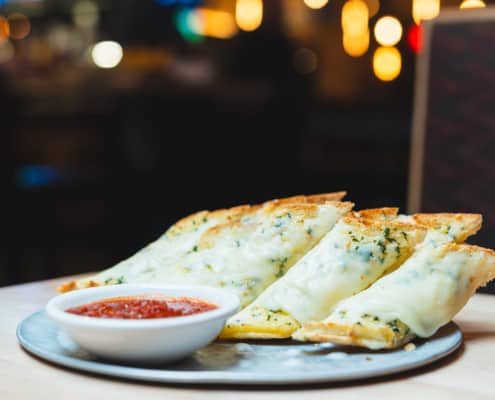 Ciabatta bread, garlic butter and mozzarella cheese. Drizzled with our basil-infused virgin olive oil. Served with a side of marinara. | Cal 900
