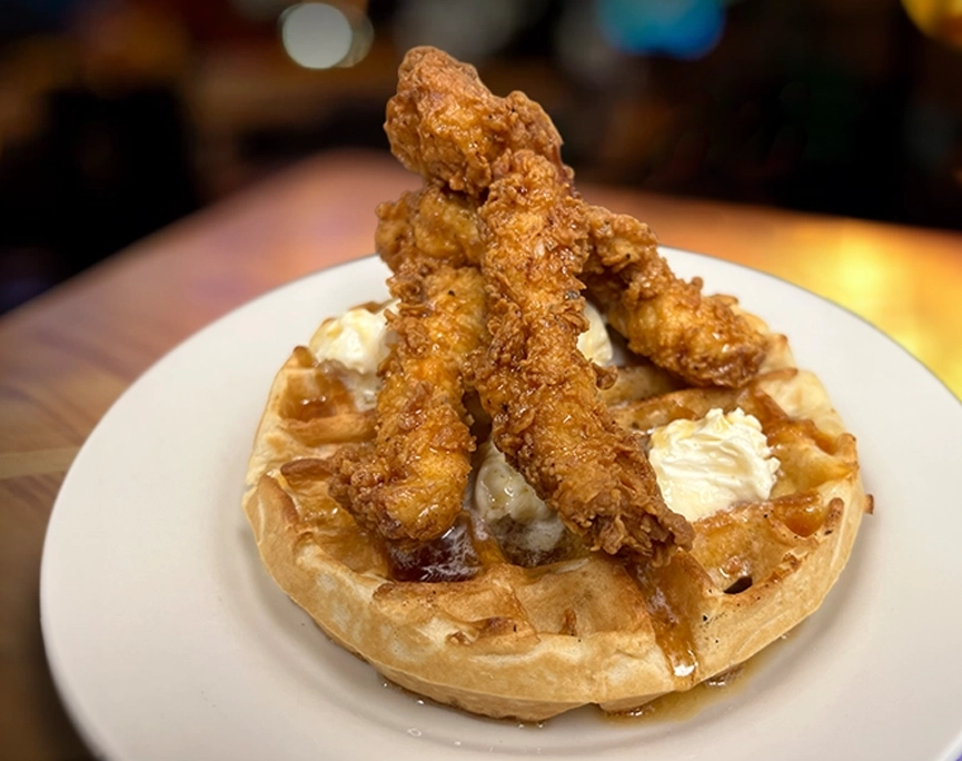 Ruby’s Pizzeria & Grill'S fresh waffle with fried chicken, hot honey, and butter on top